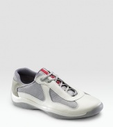 Lace-up sneaker with leather and mesh upper on a rubber sole. Padded insole Molded rubber bottom Imported 