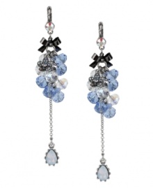 Go ahead, embellish a little. These Betsey Johnson earrings feature clusters of faceted blue and clear glass beads, a silver tone flower charm with crystal accents, a linear chain with blue-colored teardrop crystal, a hematite-plated bow accent and a small crystal accent at post. Crafted in a silver tone mixed metal setting. Approximate drop: 4 inches.