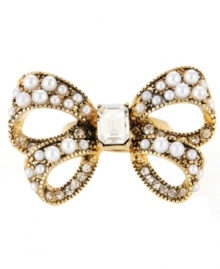 Bow-dacious! Made a bold style statement with this large-scale bow stretch ring from Betsey Johnson. Accented by glass pearls and sparkling clear crystals, it's made in gold tone mixed metal. Ring adjusts to fit finger.