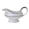 Carefully rendered in a style reminiscent of neoclassic trompe l'oeil-a French term for artwork that depicts optical illusions-a captivating geometric rosette motif traverses this elegant porcelain gravy boat from Bernardaud. Delicate shades of ice blue, mother-of-pearl and gray are enhanced by fine platinum details.