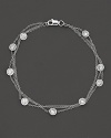 Perfectly elegant, a 3-chain white gold necklace with gleaming diamond stations.