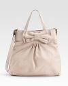 Soft, buttery leather, crafted in a slightly slouchy silhouette with a chic bow accent.Double top handles, 6½ drop Removable shoulder strap, 21 drop Snap top closure One inside zip pocket Cotton lining 18W X 15H X 4D Imported