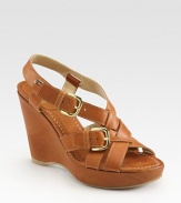 Burnished leather wedge with adjustable buckle straps and a covered platform. Self-covered wedge, 4 (100mm)Covered platform, 1 (25mm)Compares to a 3 heel (100mm)Leather upperLeather liningRubber solePadded insoleMade in SpainOUR FIT MODEL RECOMMENDS ordering true size. 