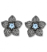 Springtime sparkle. Genevieve & Grace's delicate flower stud earrings feature a round-cut blue topaz center (1 ct. t.w.) with glittering marcasite petals. Crafted in sterling silver. Earrings feature an omega clip-on backing for non-pierced ears. Approximate diameter: 7/8 inch.