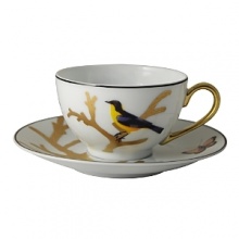 Embellished with a yellow-breasted songbird and a goldtone handle, this porcelain tea cup from Bernardaud brings an elegantly fanciful look to your table.