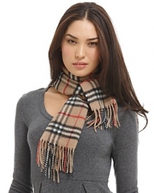 Luxuriously soft cashmere scarf in an all over check pattern is finished with fringe trim.