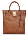 A classic design with exotic appeal, this exquisite tote from MICHAEL Michael Kors is the ultimate accessory. Croc-embossed leather and gleaming golden hardware lend a luxe look, while the spacious, pocket-lined interior keeps essentials safe and secure.