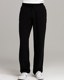 Sweat pants with two front pockets and one back pocket. Unfinished seam detail on sides. Elasticized waist with drawstring closure.