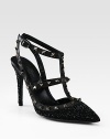 This signature t-strap pump goes uptown with glittery crystals, leather accents and edgy metal studs. Crystal-coated heel, 4¼ (110mm)Crystal coated fabric and leather upper with metal studsPoint toeAdjustable leather ankle strap with metal studsLeather lining and solePadded insoleMade in Italy