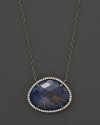 Diamonds circle a faceted rutilated quartz and blue sodalite doublet set in blackened sterling silver. By Di Massima.