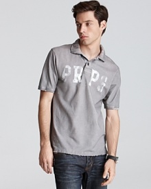 Slim fit polo with faded logo lettering and distressed accents in a slim fit.