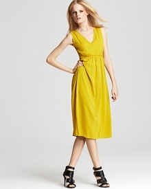 In saturated silk, this chrome yellow dress offers a classic and sophisticated silhouette with a twist. From Burberry.