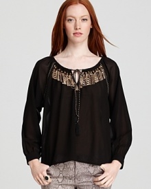 A touch of golden glamour is all it takes to step up your look at this Sanctuary blouse delivers with a metallic and sequined yoke. Team with printed denim and look haute as the temps cool.