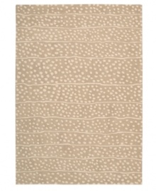 A blizzard of soft spots linger in between imperfect lines, creating beautiful harmony against a gentle sand-hued ground. Hand tufted from 100% natural wool, this plush Calvin Klein rug is crafted using the cut-and-loop pile technique that creates a unique matte surface texture.