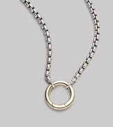 A simple ring of 18k gold hangs from a sterling silver box chain, lovely on its own, even lovelier when you add a dazzling charm. Sterling silver and 18k yellow gold Chain length, about 24 Pendant diameter, about ½ Lobster clasp Imported