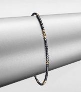 A simple chic piece that features faceted beads in blackened sterling silver accented with eight, 14k gold beaded sections. Blackened sterling silver14k goldDiameter, about 2.5Slip-on styleMade in USA