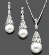 Luminous cultured freshwater pearl (7.5-9 mm) emerges from sparkling diamond-accented settings on this beautiful sterling silver jewelry set. Pendant measures approximately 18 inches with a 1-inch drop. Earrings measure approximately 1 inch.