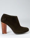 A wooden heel lends a natural contrast to soft suede, sure to appeal to design and fashion connoisseurs alike.