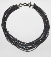 Delicate chains of blackened sterling silver are randomly sprinkled with tiny faceted beads of blue topaz, hematite and 18k gold in this dramatic design.Blue topaz and hematiteSterling silver and 18k yellow goldLength, about 18Cable toggle closureImported