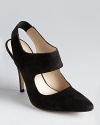 A square cutout lends a geometric feel to KORS Michael Kors' Maya pointy toe pumps, a slingback style in soft suede.