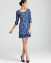 A delicate lace overlay infuses a cool-hued Catherine Malandrino dress with ladylike luxe.