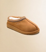 Both a shoe and slipper, this ultra-cozy, ultra-comfy style has slipper-like styling plus a sturdy sole for outdoor wear. Suede upper Sheepskin lining Heritage Tasman braid collar edging Clasic EVA outsole Imported