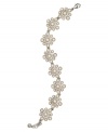 Pretty petals. A delicate floral motif defines this lovely flex bracelet from Monet. Crafted in silver tone mixed metal, it's embellished with imitation pearls as well as sparkling crystals and glass accents. Approximate length: 7-1/2 inches.