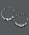 Traditional hoops with a frosty edge. Charter Club earrings feature a silver tone mixed metal hoop setting decorated with white simulated pearls and faceted plastic beads. Approximate diameter: 1-1/2 inches.