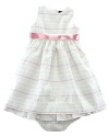 A charmingly traditional dress in multi-striped cotton seersucker has a pretty, full skirt with a petticoat and a ribbon sash.