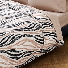 This safari-inspired zebra stripe is given a subtle sheen for understated glamour. Intensify the look with an unexpected fusion of solids and prints.