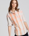 Clementine-hued stripes amp up the classic Burberry Brit button down for an on-trend pop of color. Pair with white denim for a polished summertime ensemble.