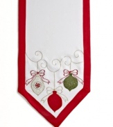 All the trimmings. Prepare for a jolly-good time with the round Holiday Ornaments tablecloth, featuring a simple white cloth festooned with holly embroidery, colorful ornaments and a scalloped edge.