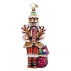 A nutcracker toting sweets and treats decorates your holiday tree.