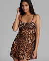 Exotic with playful charm, Betsey Johnson's animal-print chemise features rosette details and hot pink straps in the back.