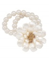 Take a turn down elegance avenue. Carolee's whimsical stretch bracelet features a large floral design that shimmers in white and clear glass beads. Accents crafted from gold tone mixed metal. Bracelet stretches to fit the wrist. Approximate diameter: 2-1/4 inches.