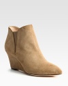 A stable wedge heightens this casual-cool suede ankle boot, with patent leather trim and side elastic gores. Self-covered wedge, 3 (75mm)Suede upper with patent leather trim and elastic goresLeather lining and solePadded insoleImportedOUR FIT MODEL RECOMMENDS ordering one half size up as this style runs small. 