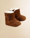 Precious baby booties crafted in ultra-plush suede with shearling lining and toggle button closure.Toggle closureLeather upperShearling leather liningLeather solePadded insoleImported