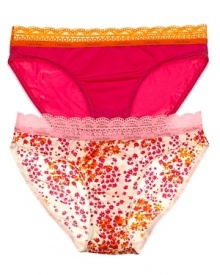 A solid or printed bikini with contrast scalloped lace trim along waistline.