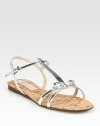 Shimmering metallic t-strap with a secure, adjustable slingback strap, topped with a sweet bow detail. Faux metallic leather upperPadded insoleImportedOUR FIT MODEL RECOMMENDS ordering one half size down as this style runs large. 