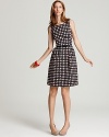 An abstract check print covers this classically feminine Sonja dress from kate spade new york, while a patent leather bow belt cinches at the waist.