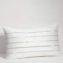 Embroidered and embellished decorative pillows complement the bedding ensemble.