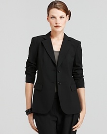 A refined piece perfect for layering year round, this DKNY jacket teams sharply with coordinating trousers for a sleek workday look.