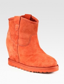 Practical and fashion-forward suede boot, lined with shearling and heightened by a hidden wedge. Suede-covered heel, 3½ (90mm)Rubber platform, ¾ (20mm)Compares to a 2¾ heel (70mm)Shaft, 7Leg circumference, 11Suede upper with grosgrain trimPull-on styleShearling liningRubber solePadded insoleImported