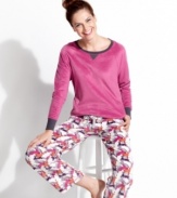 Snuggle up in these super soft microfleece pajamas by Cuddl Duds. The Ivory top features contrasting detail at the neckline and cuffs, while the roomy pants feature an elastic drawstring waist and fun all-over print.