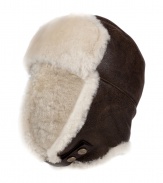 Both comfortable and stylish, UGG Australias shearling lined leather trapper cap is an ultra cozy cold weather must - Cream shearling lining, chocolate leather outside, logo snap strap - Wear with puffy parkas and matching shearling boots