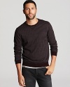 Knit entirely from soft merino wool, this clever design features thin stripes all over and solid elbow patches for unique flair.