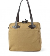 Stylish bag in fine cotton and leather - by US-label Filson, known for its luxurios and robust bags - casual tote shape (shopper) - classic camel color - tightly weaved cotton twill, water proof due to a special parafine wax coating - cowhide handles - intelligent and roomy interior, four outside pockets - functional top zipper - a favorite bag to have - genius for college, at the job, at leisure time