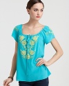 Vibrant hues and folkloric embroidery bring retro-chic style to this peasant top from Nanette Lepore.