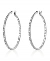 Highlight your look with a side of sparkle. These slim Monet hoop earrings are crafted in silvertone mixed metal and crystal accents. Approximate diameter: 1-3/4 inches.