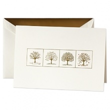 The beauty of the seasons and the holiday are artfully captured on this natural white card. Foil stamped in metallic gold, a single tree is framed and shown throughout the four seasons with colorful delicate highlights. The inside holds a simple Season's Greetings printed in gold. A metallic gold liner lends some seasonal shimmer to the matching envelope.